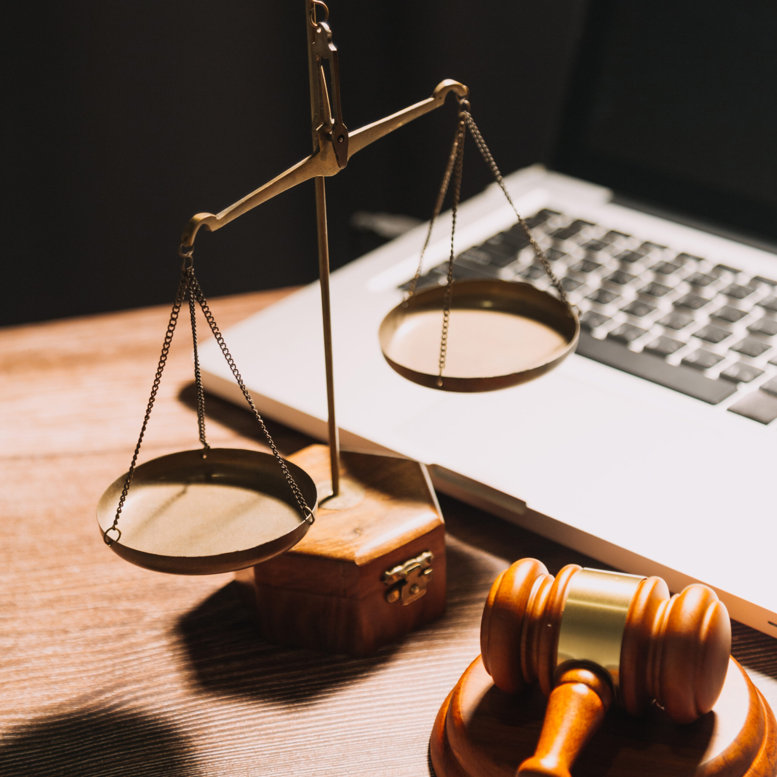 Business and lawyers discussing contract papers with brass scale on desk in office. Law, legal services, advice, justice and law concept picture with film grain effect