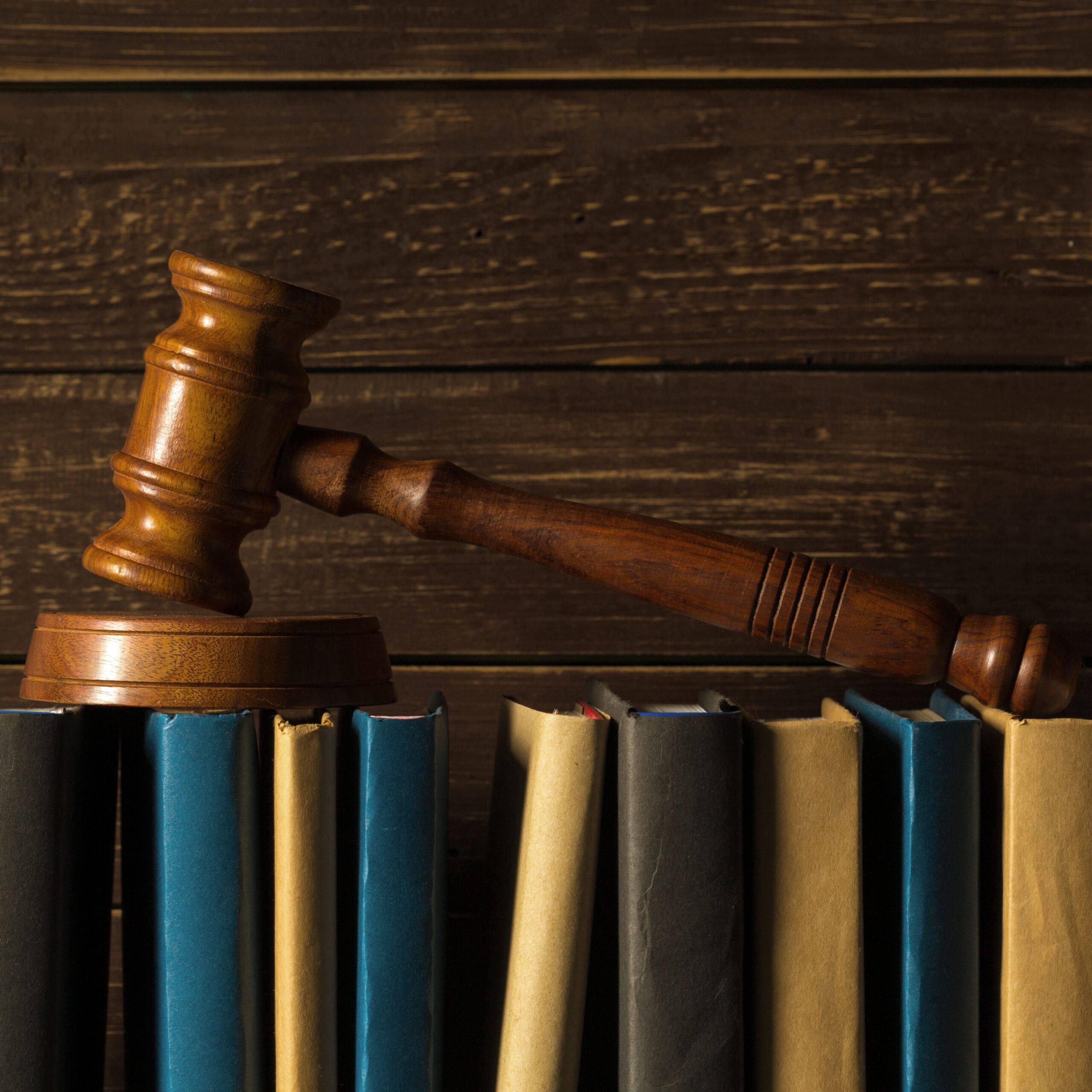 Gavel With Books On Old Wooden Desk